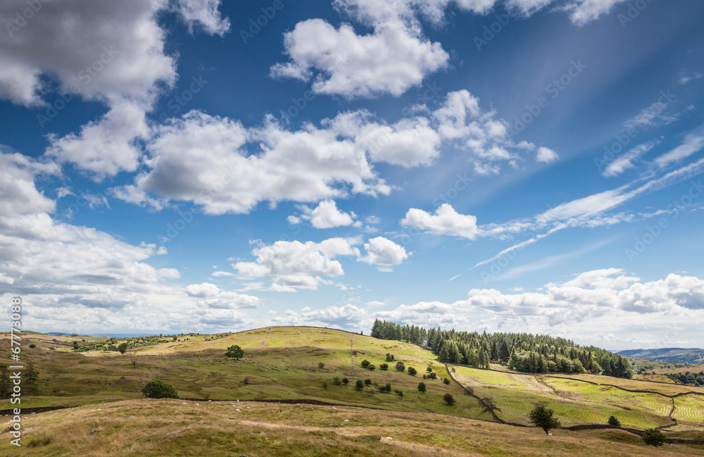 Fototapeta premium Cloudy sky over English countryside in Cumbria, UK.