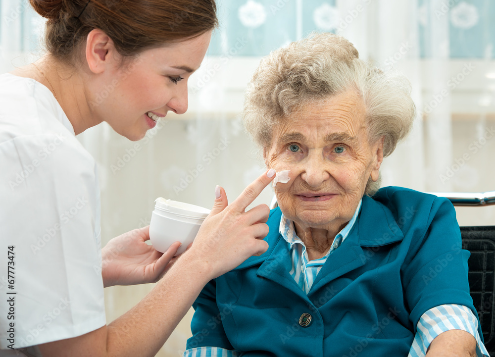 Elderly woman is assisted by nurse at home Elderly woman is assisted by nurse at home
