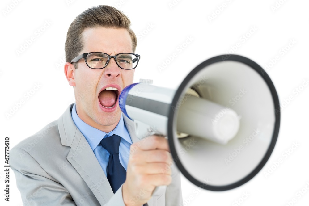 Geeky businessman shouting through megaphone Geeky businessman shouting through megaphone