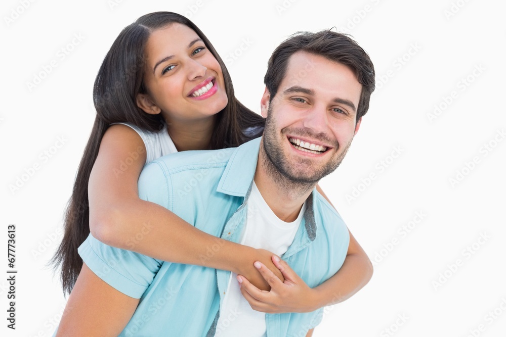 Happy casual man giving pretty girlfriend piggy back Happy casual man giving pretty girlfriend piggy back
