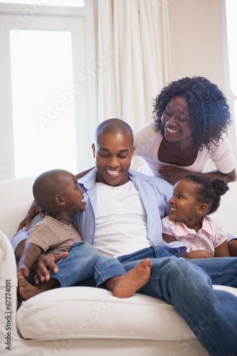 Happy family sitting on couch together