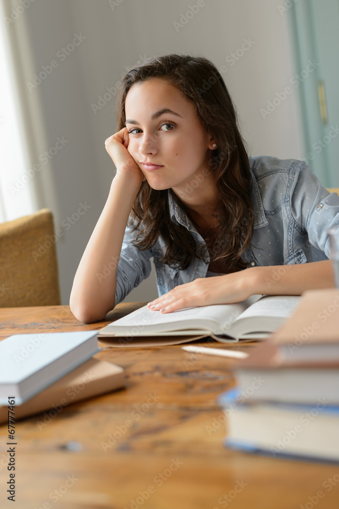 Bored teenage girl studying books at home Bored teenage girl studying books at home