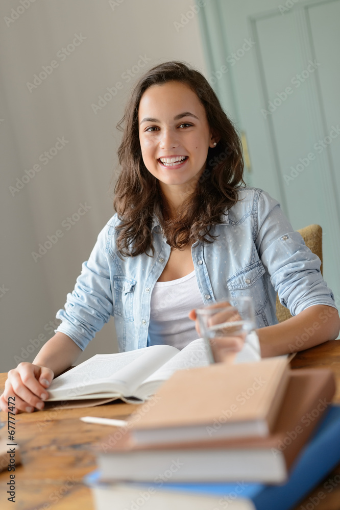 Cheerful teenage girl studying at home Cheerful teenage girl studying at home