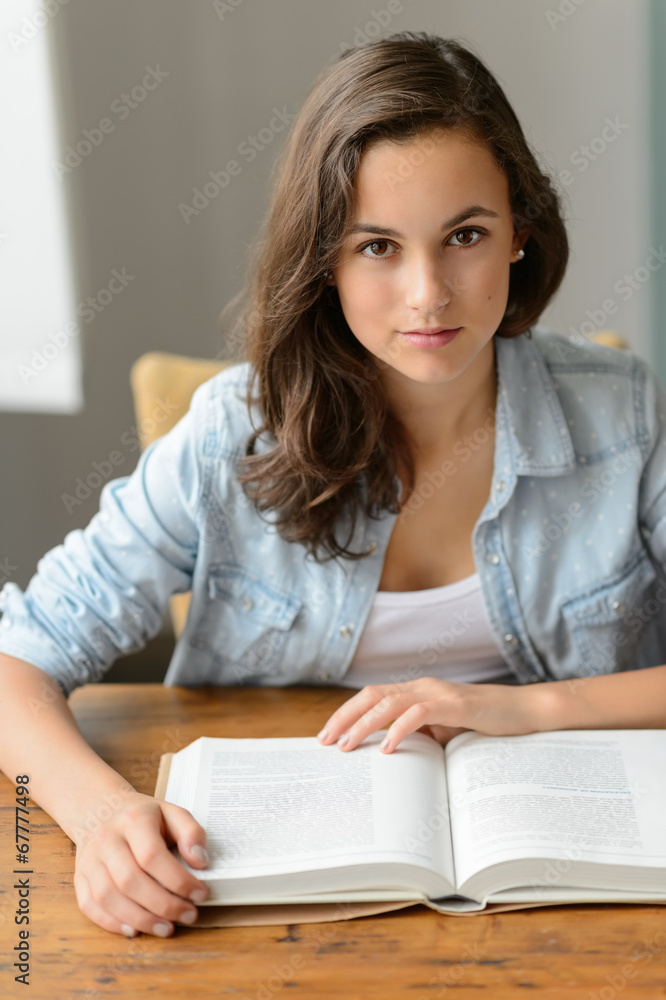 Student teenage girl reading book looking camera Student teenage girl reading book looking camera