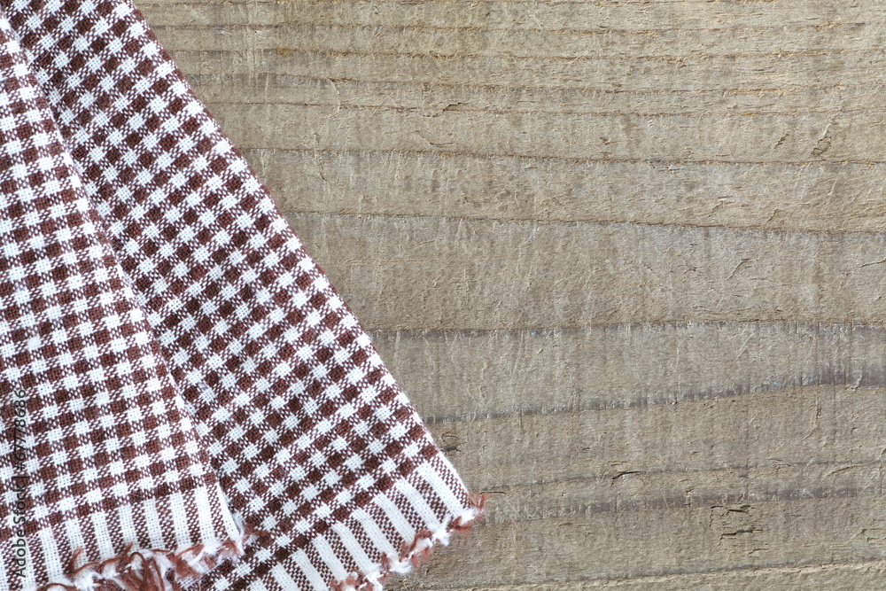 Brown tablecloth and old wooden table background Brown tablecloth and old wooden table background
