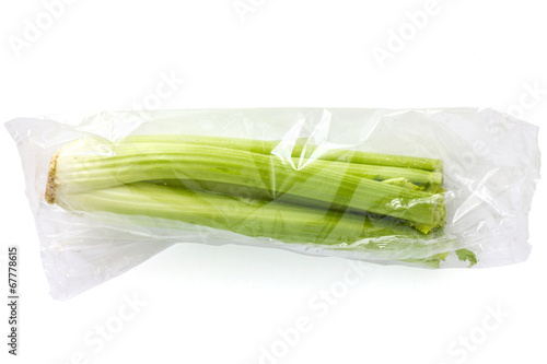 Whole celery sealed in a clear plastic bag.