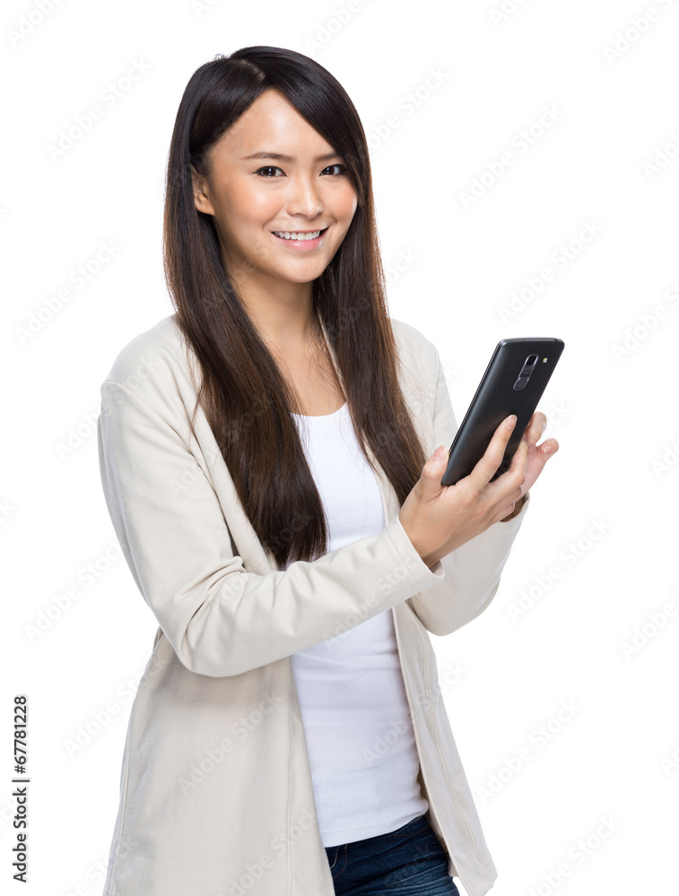 Asia young woman texting with mobile phone on white background Asia young woman texting with mobile phone on white background