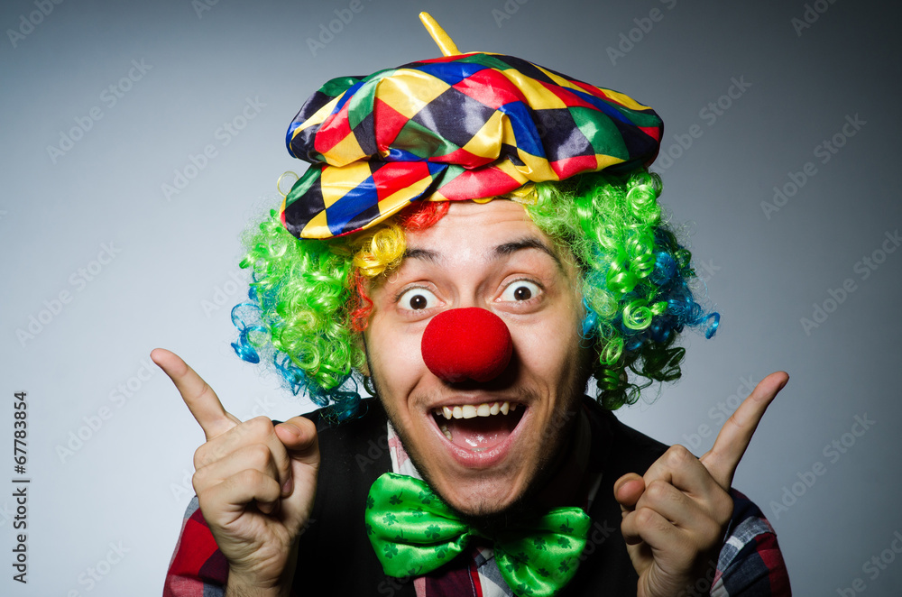 Funny clown against the dark background Funny clown against the dark background