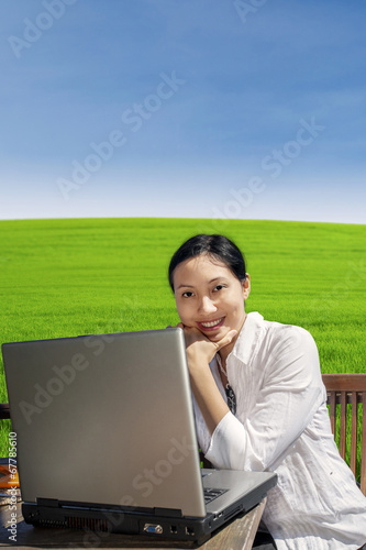 Businesswoman work with laptop in park