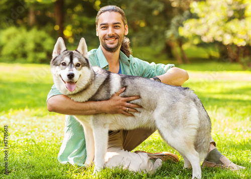 Photography Man and Husky dog walk in the park.