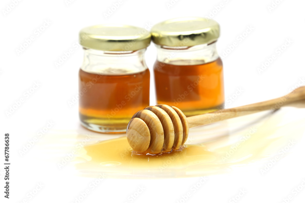 Honey and dipper on white background Honey and dipper on white background
