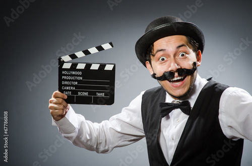 Funny man with movie clapper board