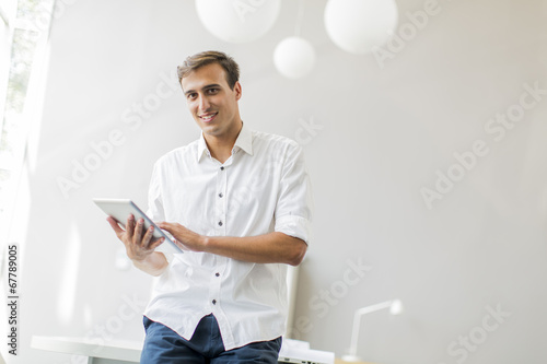 Young man with tablet in th...