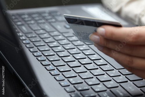woman holding credit card on laptop for online shopping concep