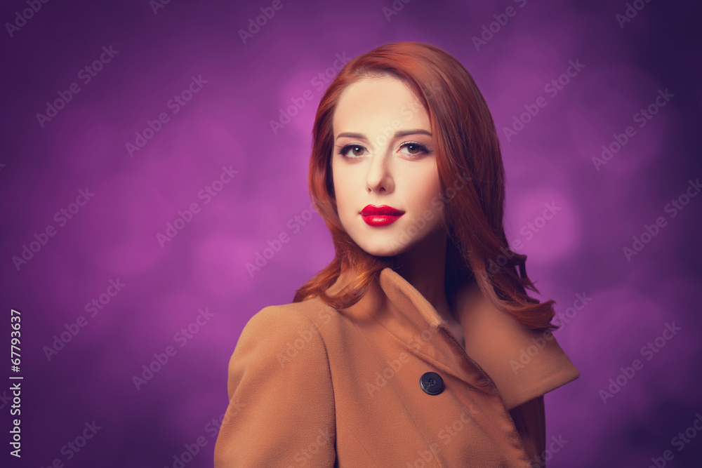 Redhead women in coat on vilolet background. Redhead women in coat on vilolet background.