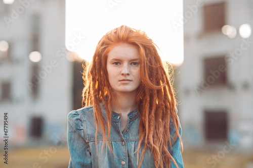 Young girl with dreadlocks outdoors photo