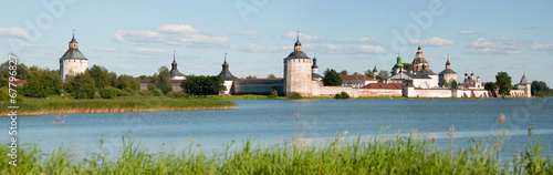 Ancient russian monastery at the lake bank in summer photo