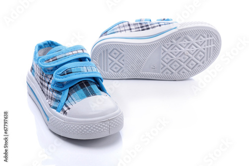 Blue sneakers for a baby on white background