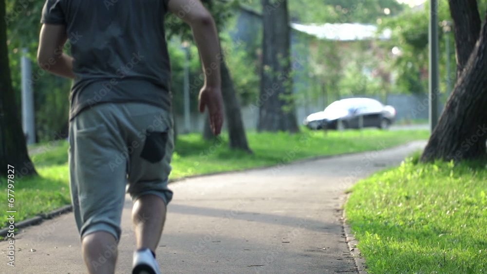 Young man jogging in city park, super slow motion, 240fps Young man jogging in city park, super slow motion, 240fps