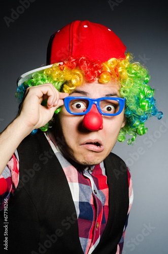 Funny clown against the dark background