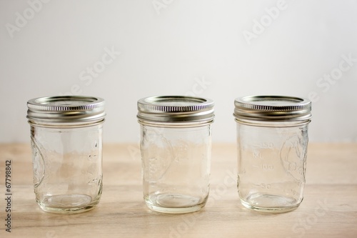 Vászonkép Empty canning jars on a wooden tabletop.
