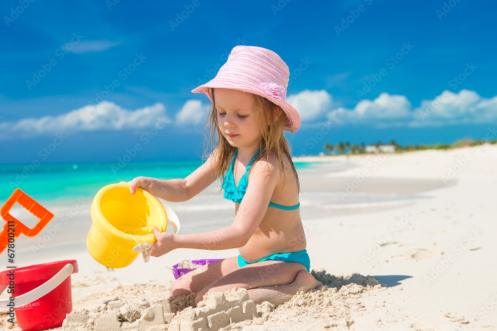 Adorable little girl playing with toys on beach vacation Adorable little girl playing with toys on beach vacation