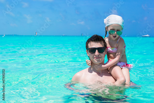 Happy father play with little daughter in the sea