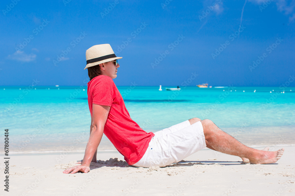 Young man enjoying summer vacation on tropical beach Young man enjoying summer vacation on tropical beach