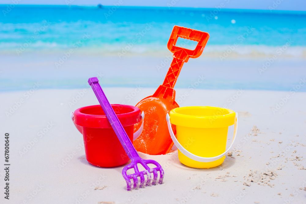 Summer kid's beach toys in the white sand Summer kid's beach toys in the white sand