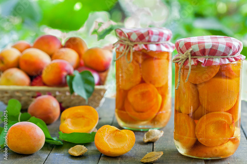 Fotografija Apricot compote with fresh apricots in basket