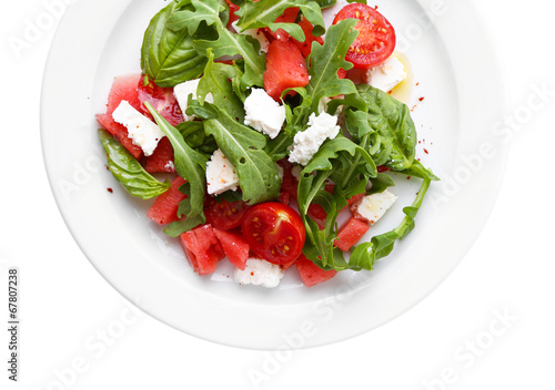 Salad with watermelon, feta, arugula and basil leaves