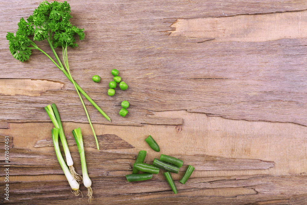 Different kind of raw vegetables on wooden table Different kind of raw vegetables on wooden table