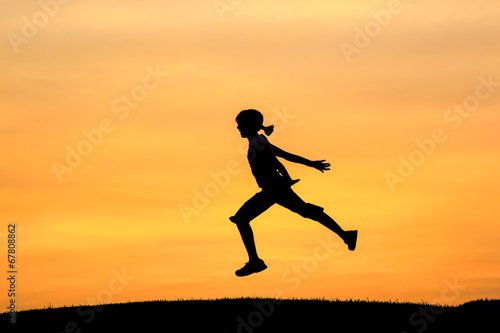 Wallpaper Mural Girl leaps during sunset. Torontodigital.ca