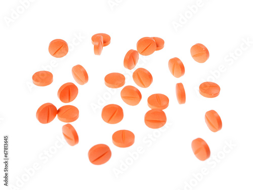 Close-up of many orange pills, selective focus