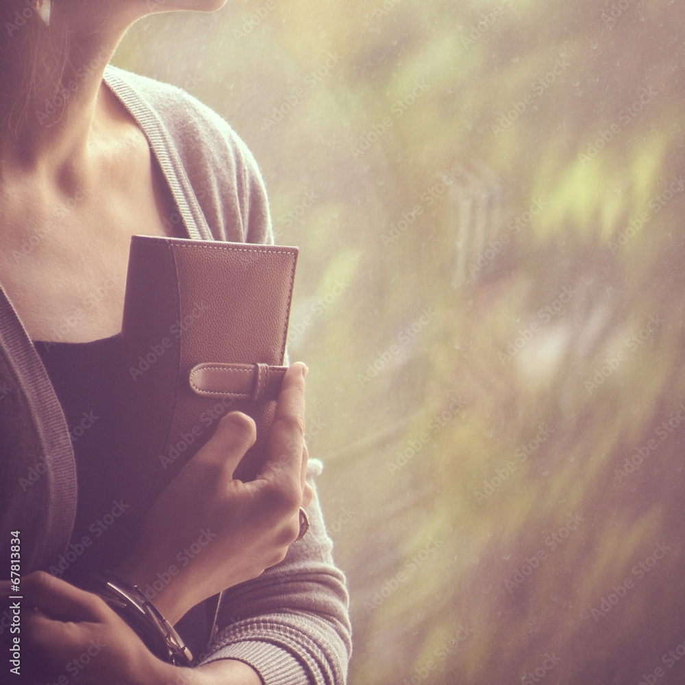background girl sitting and looking out the window and holding a background girl sitting and looking out the window and holding a