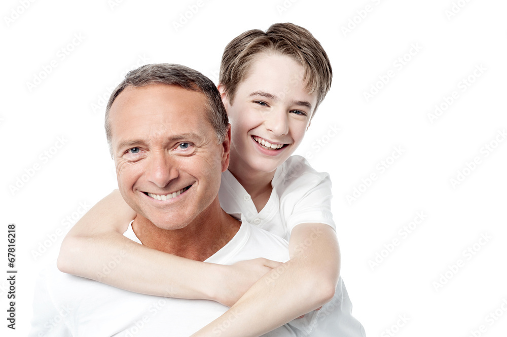 Smiling father holding son on his shoulders Smiling father holding son on his shoulders