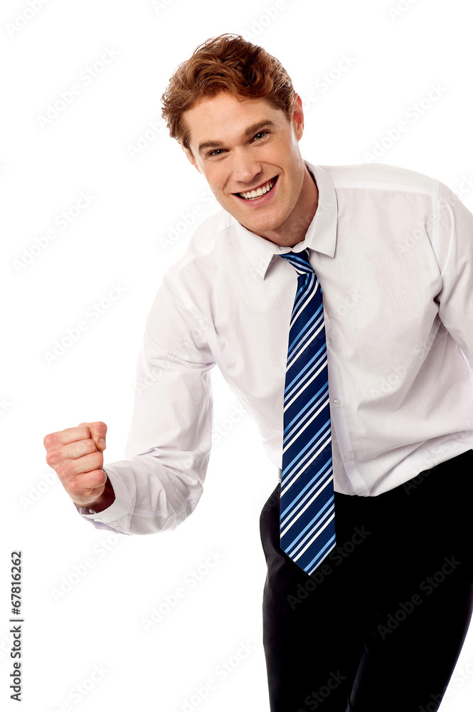 Enthusiastic corporate man clenching fist Enthusiastic corporate man clenching fist