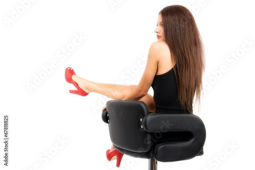 young gorgeous caucasian brunette in black dress on the chair, s photo