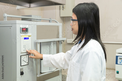Canvas Print Scientists using High Temperature Muffle Furnace in laboratory