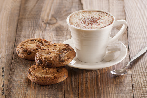 Oatmeal chocolate chip cookies with wooden background.