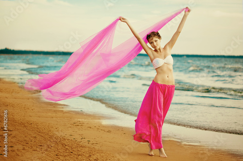 Woman with a tissue in his hands on the beach