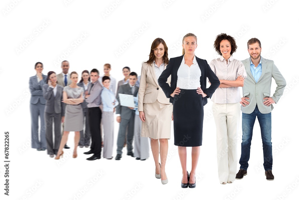 Composite image of business team looking at camera Composite image of business team looking at camera