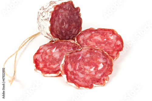 pile of red salami, on a white