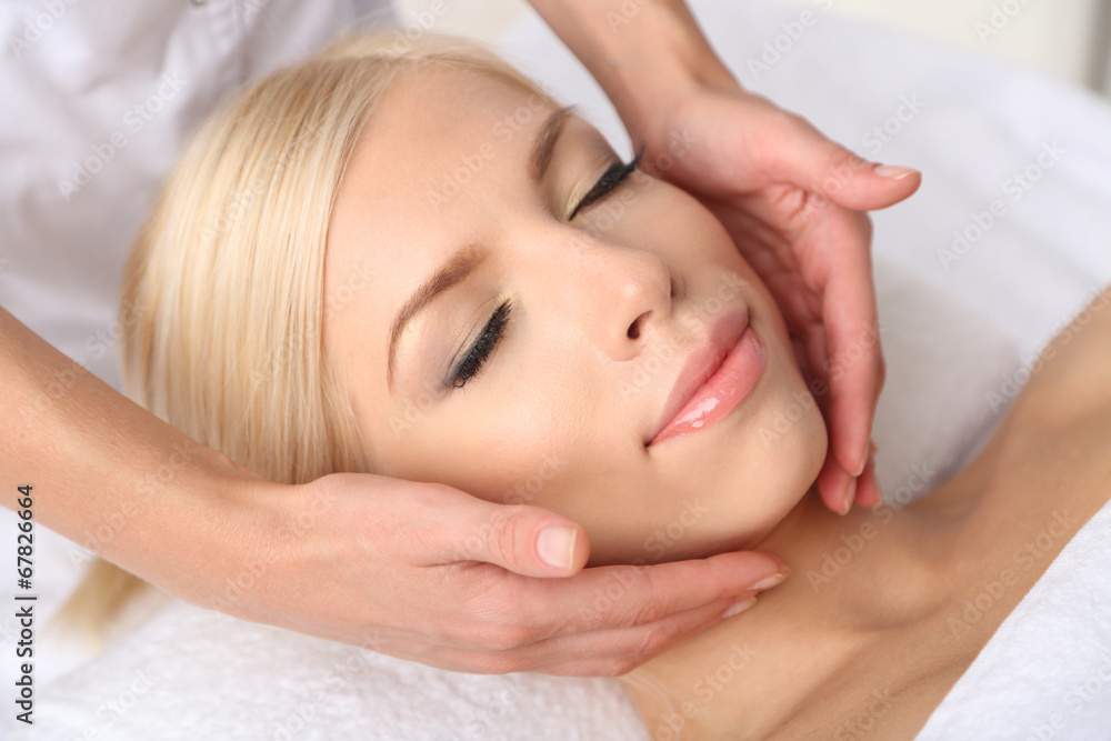 Beautiful young woman having massage in spa salon Beautiful young woman having massage in spa salon