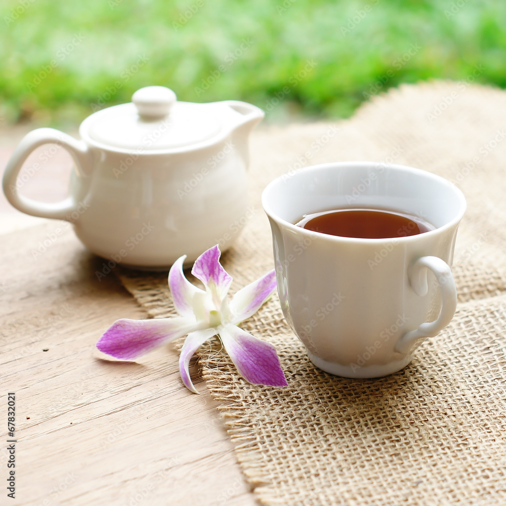 cup of black coffee with purple orchid and burlap cloth on wood cup of black coffee with purple orchid and burlap cloth on wood