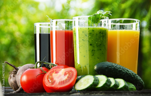 Glasses with fresh vegetable juices in the garden. Detox diet photo