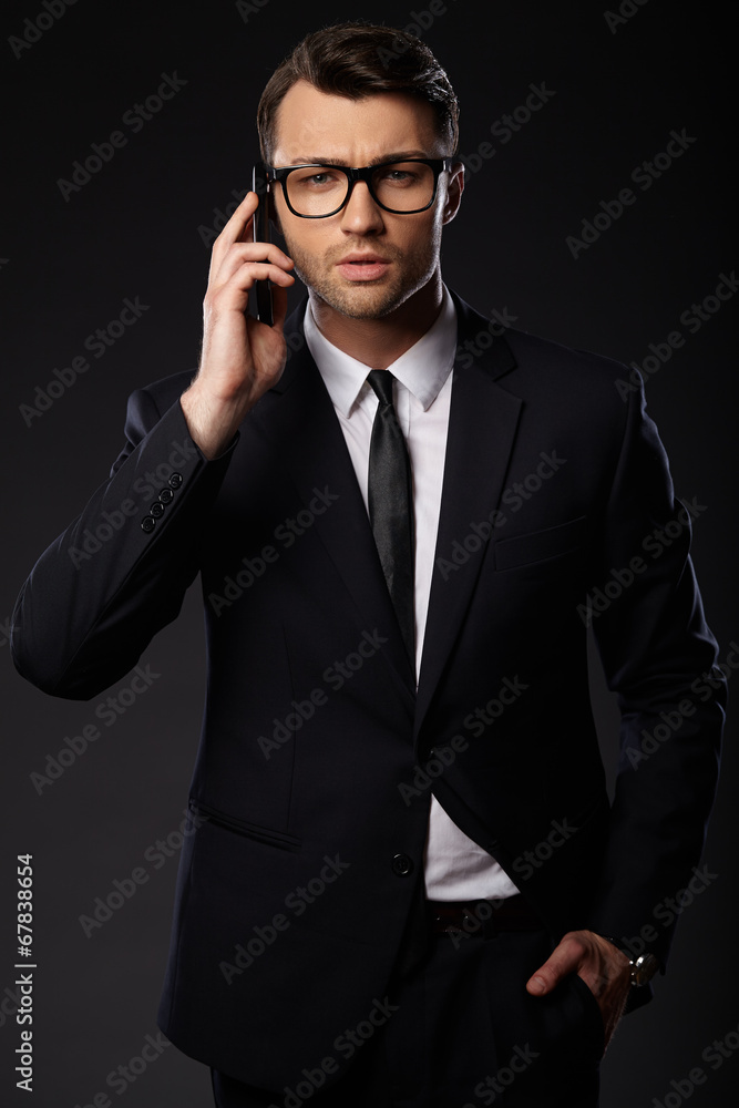 Portrait of young business man. Black background Portrait of young business man. Black background