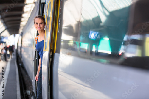 Pretty, young woman in a trainstation, waiting for her train
