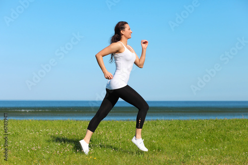 young woman jogging on the beach