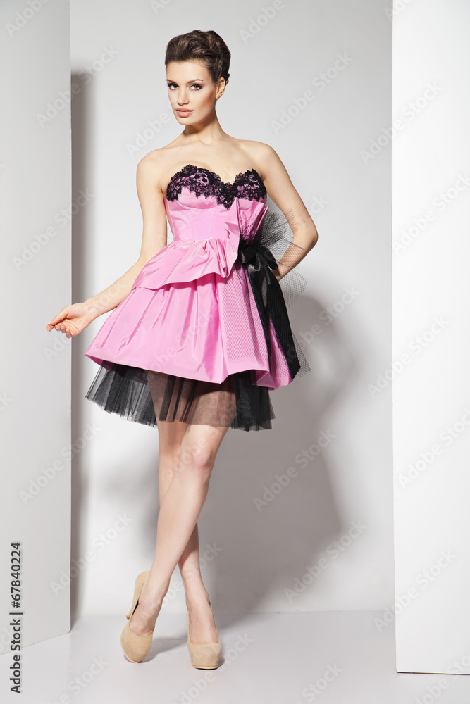 young beautiful brunette in pink dress on white young beautiful brunette in pink dress on white